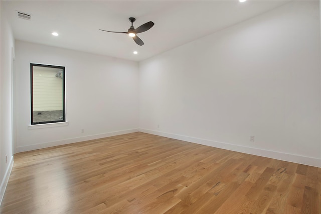 spare room with light wood-type flooring and ceiling fan