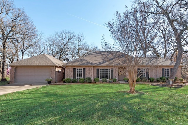 single story home with a garage and a front lawn