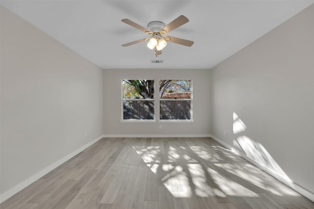 spare room with light hardwood / wood-style floors and ceiling fan