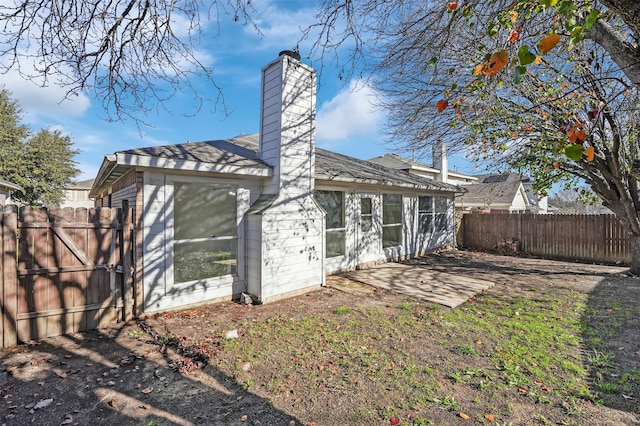 back of house with a patio