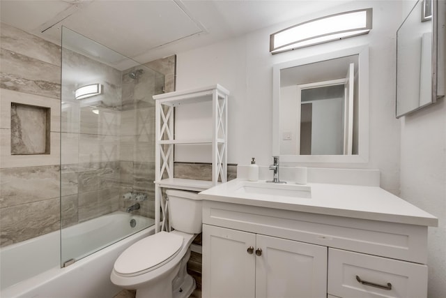 full bathroom with vanity, tiled shower / bath combo, and toilet