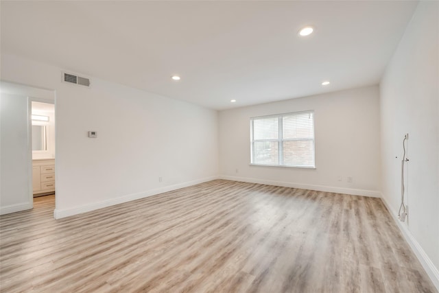 empty room with light hardwood / wood-style flooring