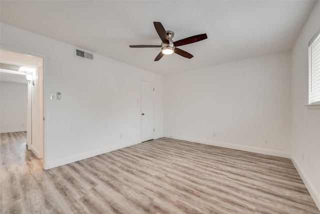 empty room with ceiling fan and light hardwood / wood-style flooring