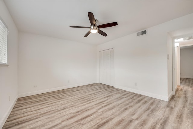 empty room featuring light hardwood / wood-style flooring and ceiling fan