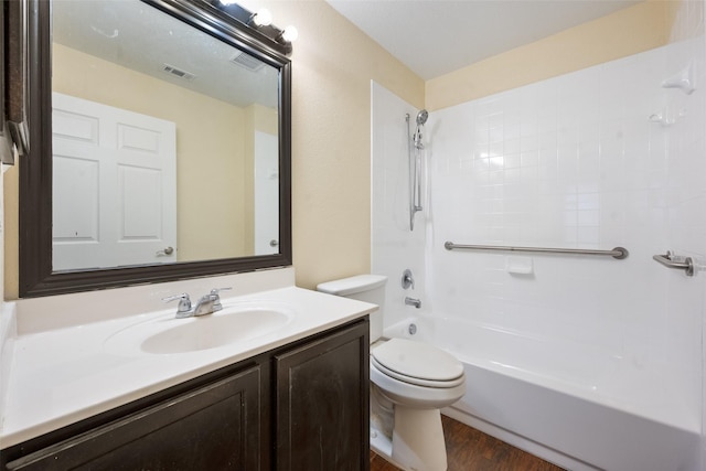 full bathroom with bathtub / shower combination, wood-type flooring, vanity, and toilet