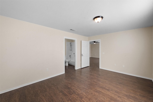 unfurnished room with ceiling fan and dark hardwood / wood-style flooring