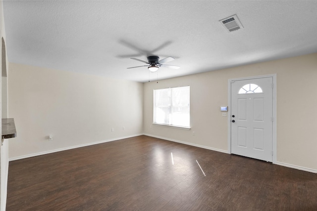 entrance foyer with a wealth of natural light, dark hardwood / wood-style flooring, and ceiling fan