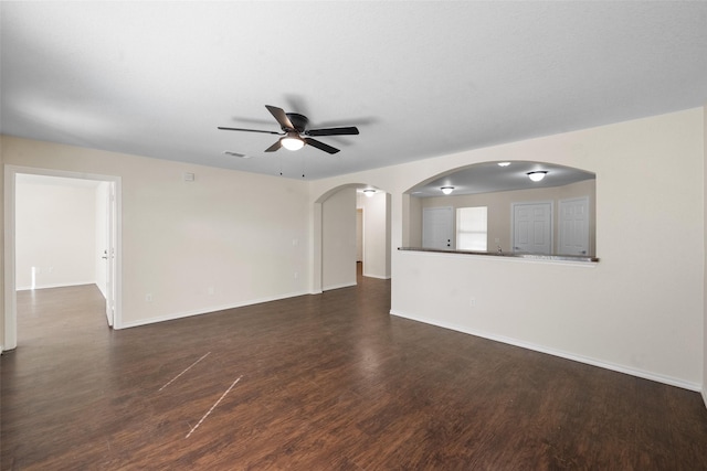 empty room featuring ceiling fan and dark hardwood / wood-style floors