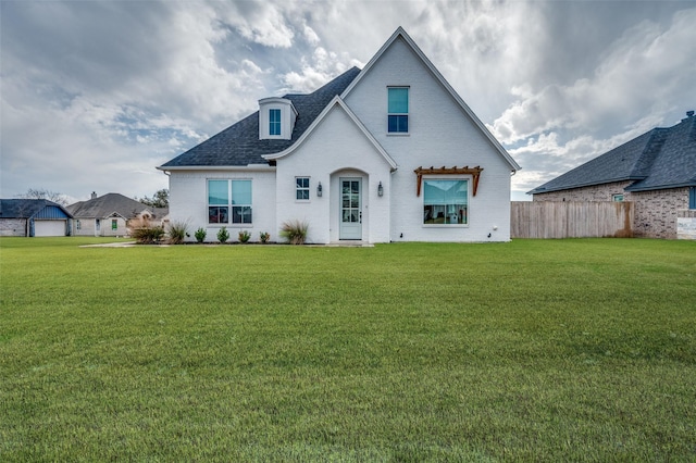 rear view of house featuring a lawn