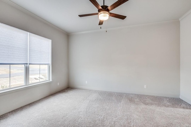 carpeted empty room featuring crown molding and ceiling fan