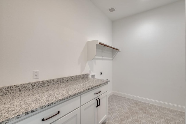 laundry room featuring hookup for an electric dryer, cabinets, and washer hookup