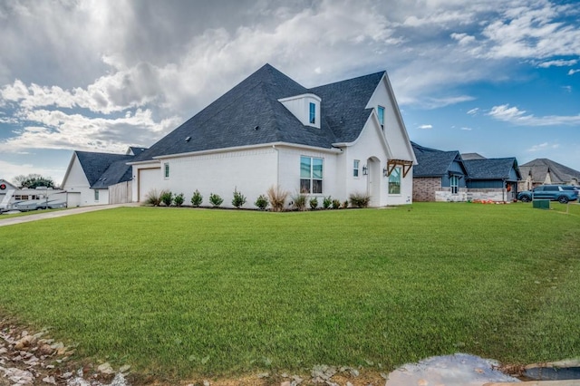 view of side of property with a lawn