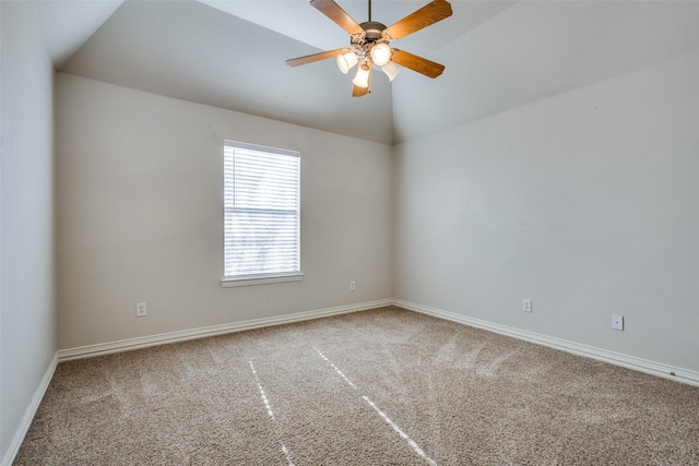 carpeted spare room featuring ceiling fan and vaulted ceiling