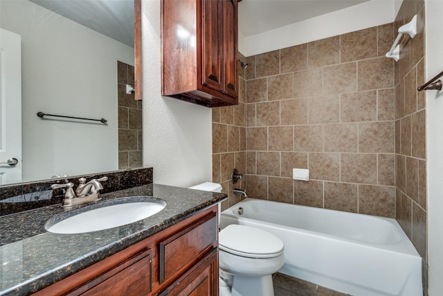 full bathroom with tile patterned floors, vanity, tiled shower / bath combo, and toilet