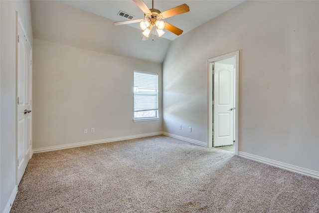 unfurnished room with ceiling fan, light colored carpet, and vaulted ceiling