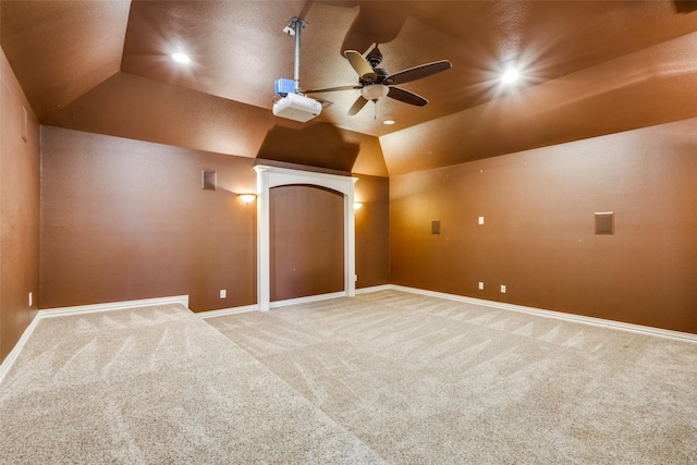 carpeted cinema featuring ceiling fan and vaulted ceiling