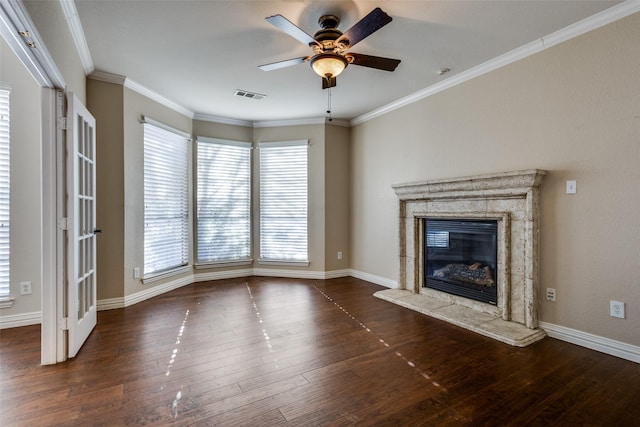 unfurnished living room with a wealth of natural light, crown molding, a fireplace, and ceiling fan