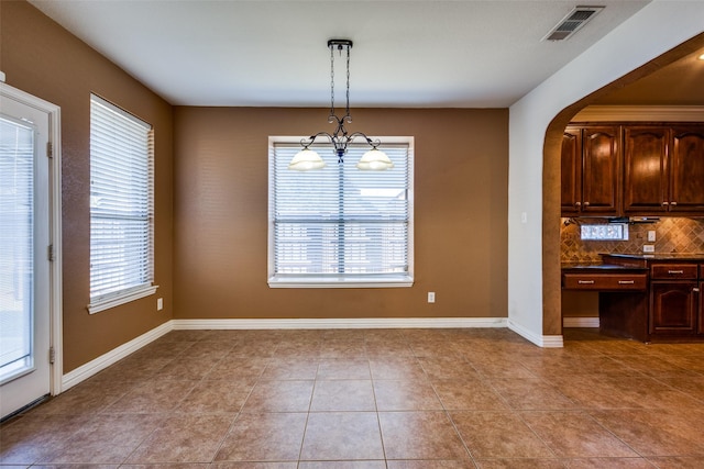 unfurnished dining area with plenty of natural light and light tile patterned floors