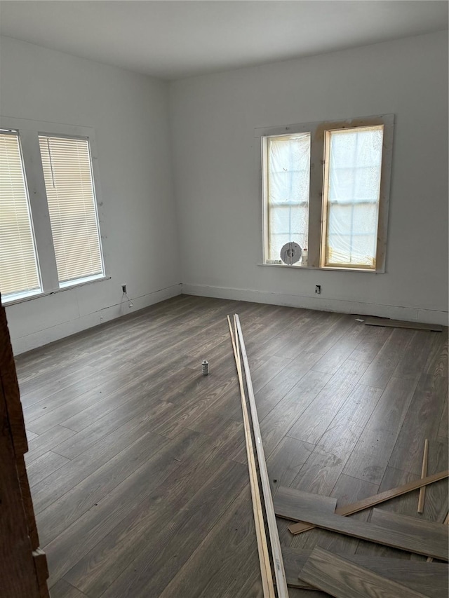 unfurnished room with wood-type flooring