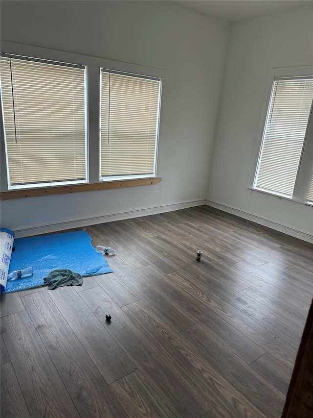 unfurnished room with dark hardwood / wood-style floors