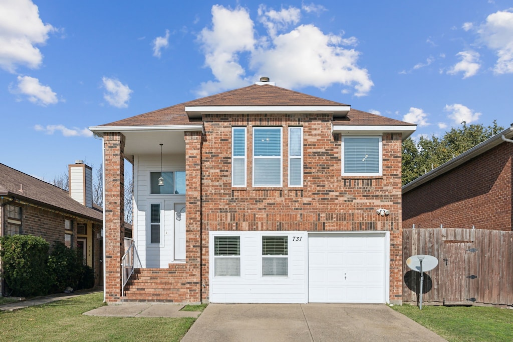 view of front facade featuring a front yard and a garage