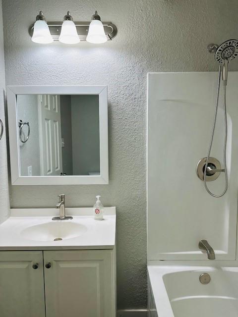 bathroom featuring vanity and shower / bath combination