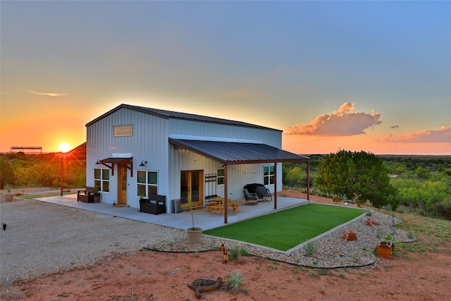 back house at dusk with a patio