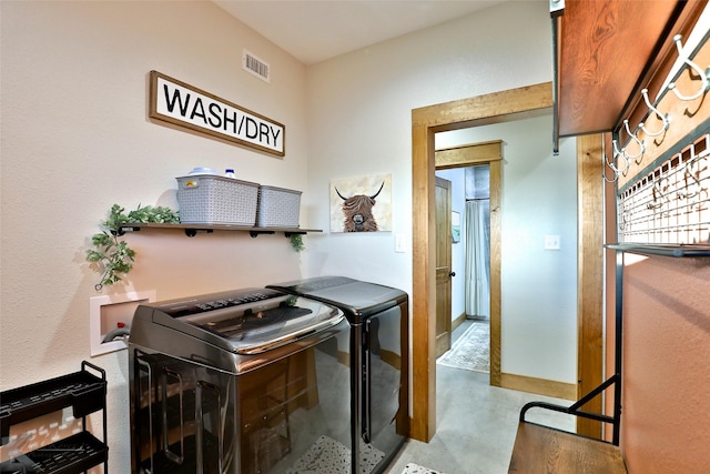 kitchen with washing machine and clothes dryer