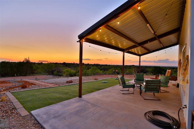 patio terrace at dusk with a lawn