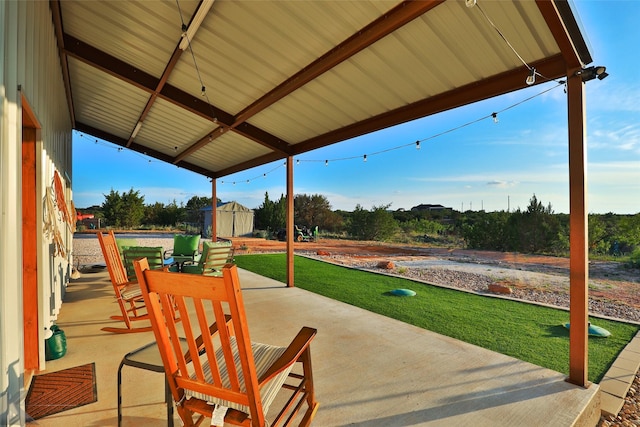 view of patio / terrace with a gazebo and a storage unit