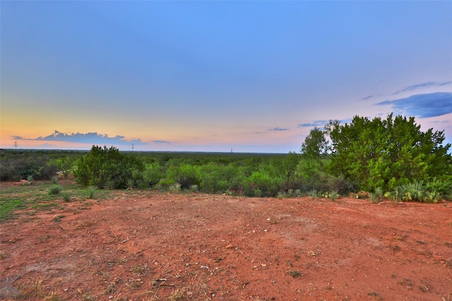 nature at dusk featuring a rural view