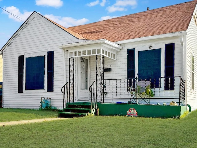 back of property featuring a lawn