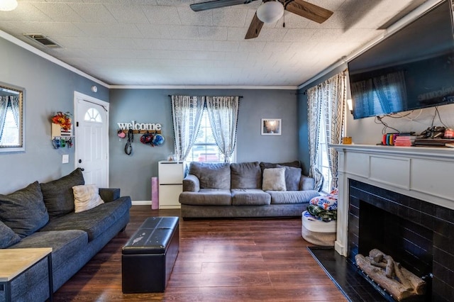 living room with dark hardwood / wood-style floors, ceiling fan, and crown molding