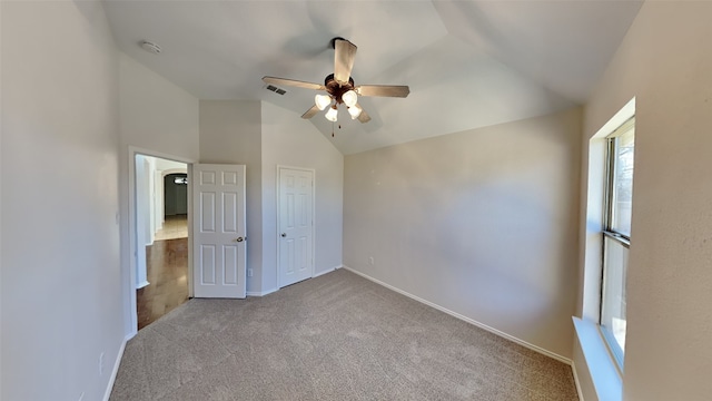 unfurnished bedroom featuring ceiling fan, light colored carpet, and lofted ceiling