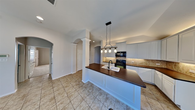 kitchen with black appliances, pendant lighting, white cabinetry, and sink