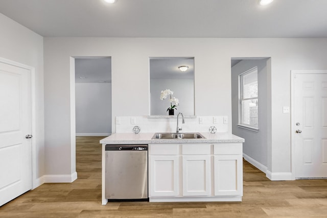 kitchen with dishwasher, sink, decorative backsplash, light wood-type flooring, and white cabinetry