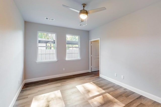 empty room with light hardwood / wood-style floors and ceiling fan