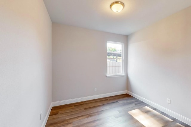 spare room with hardwood / wood-style floors