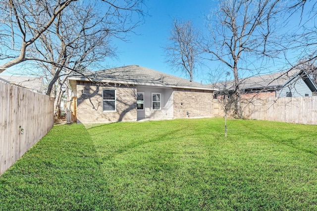 back of house featuring a yard