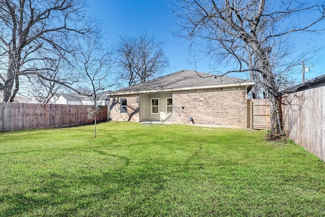 back of property featuring a lawn