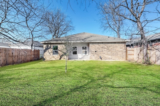 rear view of property with a yard