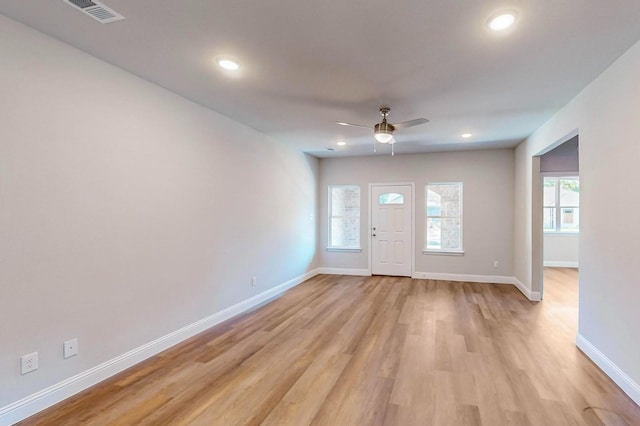 entrance foyer with light hardwood / wood-style flooring, ceiling fan, and a healthy amount of sunlight