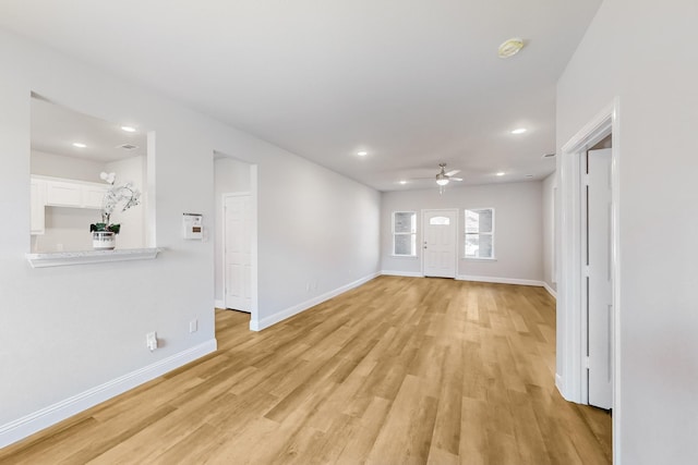 interior space featuring ceiling fan and light wood-type flooring