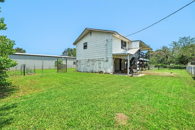 rear view of property featuring a yard