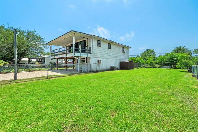 back of house featuring a lawn and cooling unit