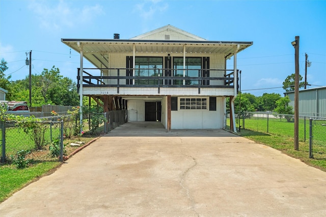 view of front of house featuring a balcony and a front lawn