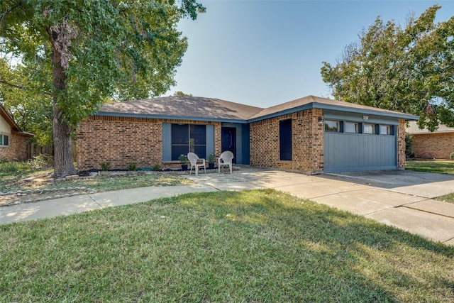 ranch-style home featuring a garage and a front yard