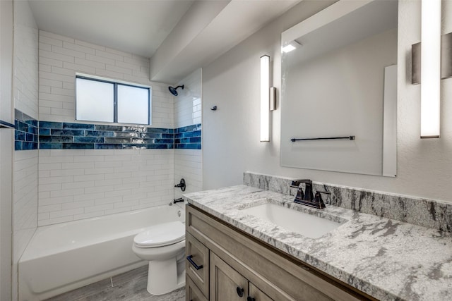 full bathroom with vanity, toilet, and tiled shower / bath