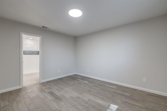 unfurnished room with light hardwood / wood-style floors