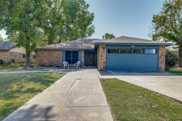 single story home with a front yard and a garage